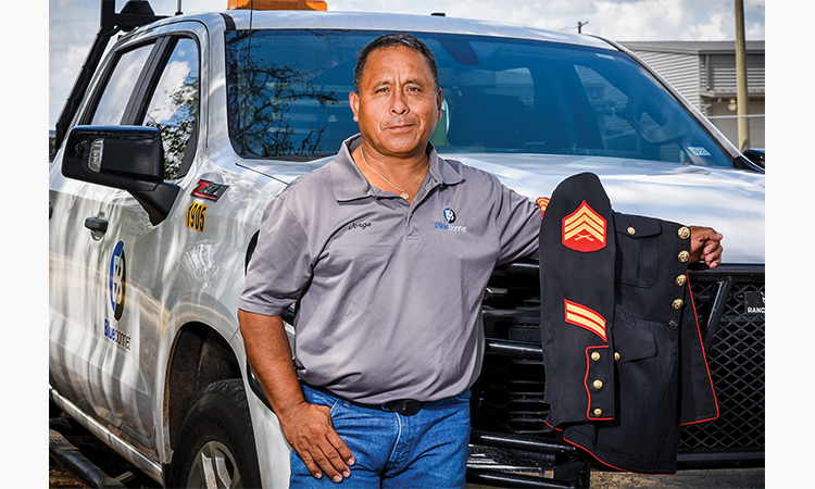 Jorge Varillas with his ceremonial dress blues jacket from his 10 years in the U.S. Marines, left. He has worked at Bluebonnet 26 years and today is a project coordinator.