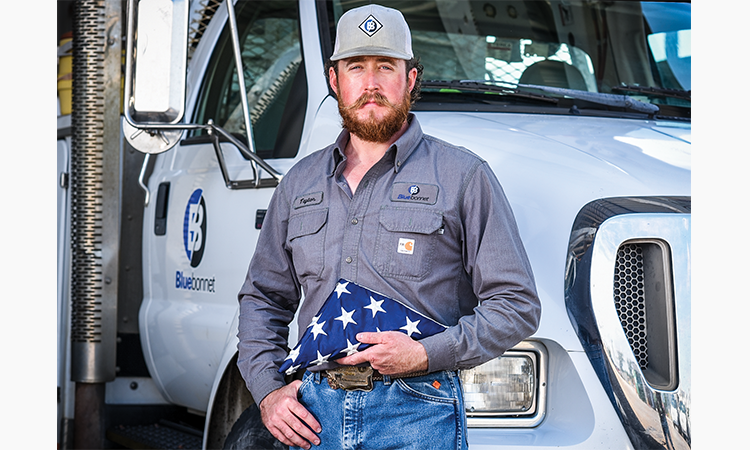 Taylor Rutledge holds the American flag that flew in the back of his medevac unit’s Black Hawk helicopter in Afghanistan.